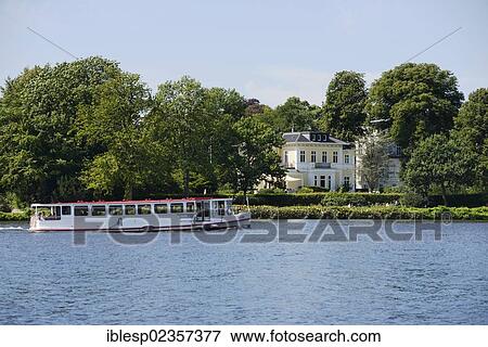 Stock Photo - "Alster river steamer on the Aussenalster or Outer Alster Lake, mansion at back, Hamburg, Hamburg, Germany, Europe". Fotosearch