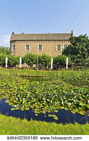 Stock Photo - "Altes Schloss, old castle, with terrace of the restaurant and pond, Grevenbroich, North Rhine-Westphalia, Germany, Europe". Fotosearch
