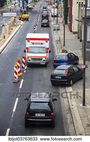"Ambulance driving against the traffic at a construction site during an emergency operation, other cars driving off the road to allow free passage, Essen, North Rhine-Westphalia, Germany, Europe" View Large Photo Image Stock Image - "Ambulance driving against the traffic at a construction site during an emergency operation, other cars driving off the road to allow free passage, Essen, North Rhine-Westphalia, Germany, Europe". Fotosearch