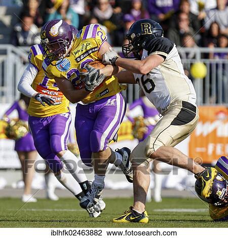 Stock Image - "American football, RB Florian Hiess, No. 23 Vikings, is tackled, Kornmesser Rangers vs. Vienna Vikings, Vienna, Vienna State, Austria, Europe". Fotosearch
