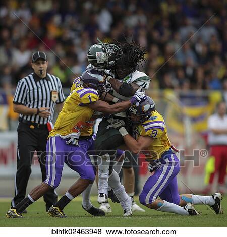 "American football, RB Tunde Ogun, No. 1 Dragons, is tackled by DB Tillman Stevens, No. 1 Vikings, and DB Peter Tutsch, No. 9 Vikings, Vienna Vikings vs. Danube Dragons, Vienna, Vienna State, Austria, Europe" View Large Photo Image Stock Photo - "American football, RB Tunde Ogun, No. 1 Dragons, is tackled by DB Tillman Stevens, No. 1 Vikings, and DB Peter Tutsch, No. 9 Vikings, Vienna Vikings vs. Danube Dragons, Vienna, Vienna State, Austria, Europe". Fotosearch