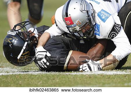 Stock Photography - "American football, Zacchaeus McCaskill, No. 3 Rangers, is tackled by LB Julian Hackl, No. 34 Raiders, Kornmesser Rangers vs. Swarco Raiders Tirol, Vienna, Vienna State, Austria, Europe". Fotosearch