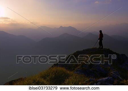 Stock Photo - "Ammer Mountains with climber at sunrise, Fussen, Ostallgau, Allgau, Schwabia, Bavaria, Germany, Europe". Fotosearch