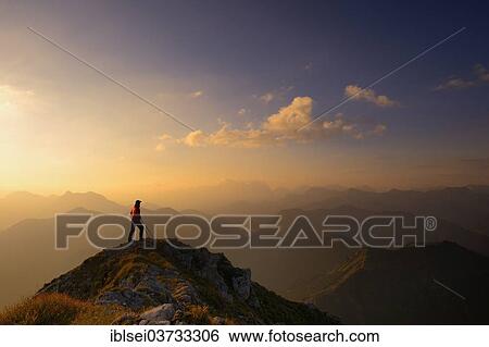 Stock Photograph - "Ammer Mountains with climber at sunrise, Fussen, Ostallgau, Allgau, Schwabia, Bavaria, Germany, Europe". Fotosearch