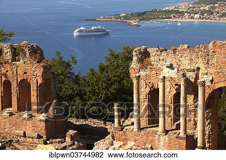 Stock Image - "Ampitheatre, cruise ship below, Taormina, Province of Messina, Sicily, Italy, Europe". Fotosearch