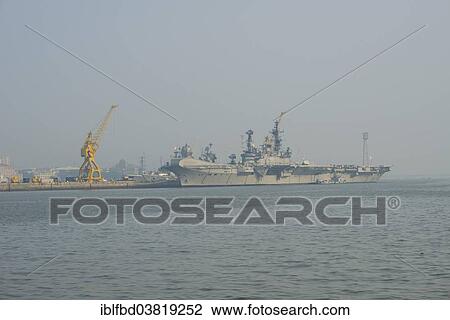Stock Image - "An aircraft carrier anchored in the Navy harbour, Mumbai, Maharashtra, India, Asia". Fotosearch