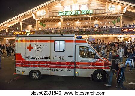 Stock Image - "An ambulance standing in the crowd, Cannstatter Wasen fairground, funfair, Bad Cannstatt, Stuttgart, Baden-Wuerttemberg, Germany, Europe". Fotosearch