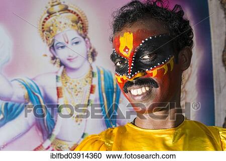Stock Image - "An artist with the complete make up of the character Garuda for the procession during a temple festival, Ayroor, Kerala, India, Asia". Fotosearch