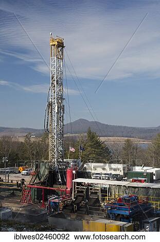 Stock Image - "An Atlas Energy Resources natural gas well being drilled in rural Lycoming County in preparation for hydraulic fracturing or fracking, Rose Valley Lake at back, Williamsport, Pennsylvania, United States, North America". Fotosearch