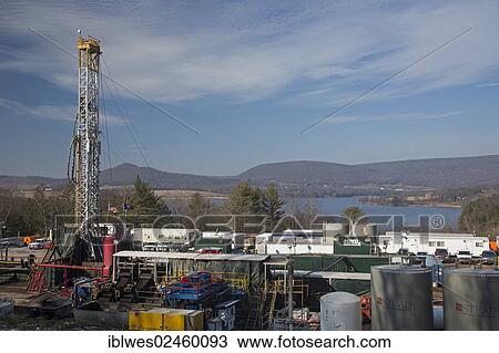 Stock Image - "An Atlas Energy Resources natural gas well being drilled in rural Lycoming County in preparation for hydraulic fracturing or fracking, Rose Valley Lake at back, Williamsport, Pennsylvania, United States, North America". Fotosearch