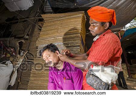 Stock Photo - "An ear cleaner at work at Mangaldas Market, Mumbai, Maharashtra, India, Asia". Fotosearch