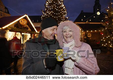 Stock Image - "An elderly couple at the Christmas market in Annaberg-Buchholz, Saxony, Germany, Europe". Fotosearch