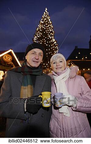 Stock Image - "An elderly couple at the Christmas market in Annaberg-Buchholz, Saxony, Germany, Europe". Fotosearch