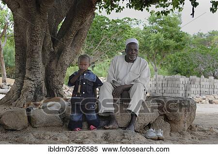 "An elderly man and a child under a tree, Rhumsiki, Far North, Cameroon, Africa" View Large Photo Image Stock Photography - "An elderly man and a child under a tree, Rhumsiki, Far North, Cameroon, Africa". Fotosearch