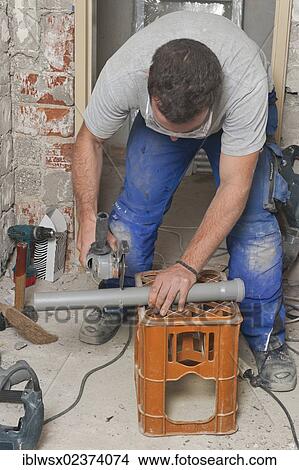 "An electrician, systems mechanic for sanitary engineering, heating and air conditioning, installing a sewer pipe, cuting the pipe to length, refurbishment, Baden-Wuerttemberg, Germany, Europe" View Large Photo Image Picture - "An electrician, systems mechanic for sanitary engineering, heating and air conditioning, installing a sewer pipe, cuting the pipe to length, refurbishment, Baden-Wuerttemberg, Germany, Europe". Fotosearch