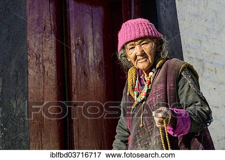"An old Ladakhi woman holding her mala, Buddhist prayer beads, at Lamayuru Gompa, Ladakh, Jammu and Kashmir, India, Asia" View Large Photo Image Stock Photo - "An old Ladakhi woman holding her mala, Buddhist prayer beads, at Lamayuru Gompa, Ladakh, Jammu and Kashmir, India, Asia". Fotosearch
