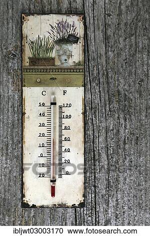 An old thermometer hanging on a weathered wooden wall View Large Photo Image Stock Image - An old thermometer hanging on a weathered wooden wall. Fotosearch