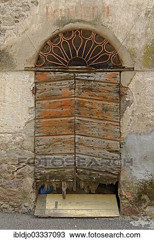 "An old wooden door and a decaying facade, Calenzana, Corsica, France, Europe" View Large Photo Image Stock Image - "An old wooden door and a decaying facade, Calenzana, Corsica, France, Europe". Fotosearch
