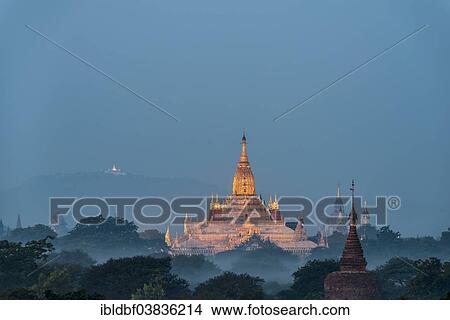 Picture - "Ananda Temple in the morning fog, blue hour, gilded tower structure or Shikhara, stupas, pagodas, temple complex, Plateau of Bagan, Mandalay Division, Burma or Myanmar". Fotosearch