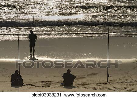 Stock Image - "Anglers in the morning light on the beach, iSimangaliso Wetland Park, St. Lucia or St. Lucia Estuary, Elephant Coast, KwaZulu-Natal, South Africa, Africa". Fotosearch