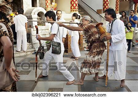 Stock Image - "Animist hermit say healing prayers and tell fortunes at Doi Suthp Buddhist temple in Chiang Mai, Thailand, Asia". Fotosearch
