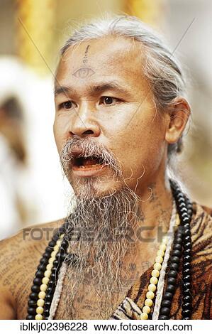 Stock Photo - "Animist hermit says healing prayers and tells fortunes at Doi Suthp Buddhist temple in Chiang Mai, Thailand, Asia". Fotosearch