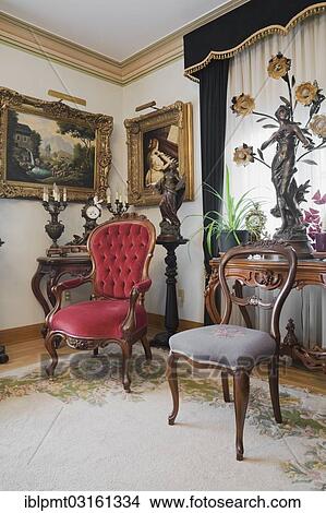 Picture - "Antique chairs and furnishings adorn a living room inside a Victorian mansion, Quebec Province, Canada, North America". Fotosearch
