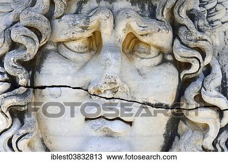 Stock Image - "Antique Medusa or Gorgon head at the Apollon temple, archaeological site of Didyma, Ionia, Aydin Province, Turkey, Asia". Fotosearch