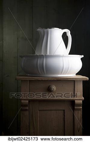 Antique porcelain basin on a small chest of drawers View Large Photo Image Stock Image - Antique porcelain basin on a small chest of drawers. Fotosearch