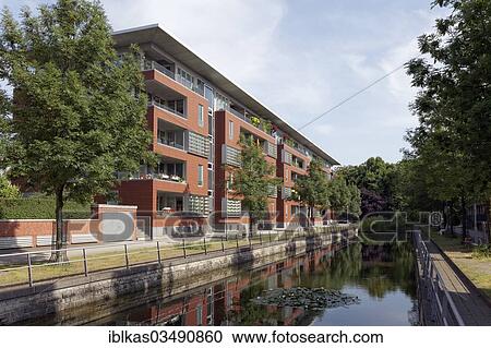 Stock Image - "Apartment houses at Speichergracht canal, designed by Sir Norman Foster, Innenhafen, Duisburg, Ruhr district, North Rhine-Westphalia, Germany, Europe". Fotosearch