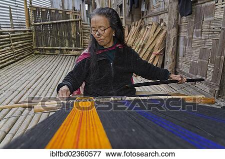 "Apatani woman weaving material on a traditional hand loom, Hani, India, Asia" View Large Photo Image Stock Photo - "Apatani woman weaving material on a traditional hand loom, Hani, India, Asia". Fotosearch