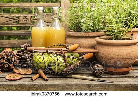 "Apples and apple juice with spices, on a wooden bench in a garden, Germany, Europe" View Large Photo Image Stock Image - "Apples and apple juice with spices, on a wooden bench in a garden, Germany, Europe". Fotosearch