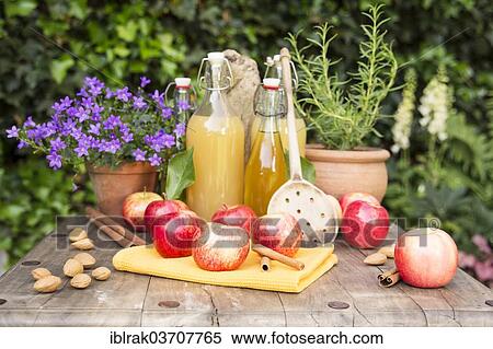 "Apples and apple juice with spices on a wooden table in the garden, Germany, Europe" View Large Photo Image Stock Photography - "Apples and apple juice with spices on a wooden table in the garden, Germany, Europe". Fotosearch