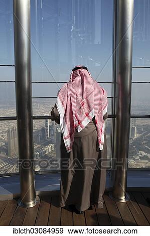 "Arab looking out from the observation deck AT THE TOP on the 124th floor at a height of about 500m in Burj Khalifa, the tallest tower in the world, Dubai, Emirate of Dubai, United Arab Emirates, Asia" View Large Photo Image Stock Photo - "Arab looking out from the observation deck AT THE TOP on the 124th floor at a height of about 500m in Burj Khalifa, the tallest tower in the world, Dubai, Emirate of Dubai, United Arab Emirates, Asia". Fotosearch