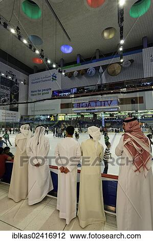 Arabs wearing traditional white dishdasha robes watching ice skaters, Dubai Ice Rink, Dubai Mall, United Arab Emirates, Middle East, Asia View Large Photo Image Stock Image - Arabs wearing traditional white dishdasha robes watching ice skaters, Dubai Ice Rink, Dubai Mall, United Arab Emirates, Middle East, Asia. Fotosearch