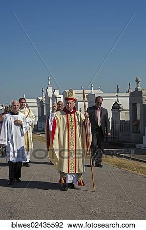 "Archbishop Gregory Aymond leads the Blessing of the Graves at St. Louis #3 Cemetery on All Saints Day, New Orleans, Louisiana, USA" View Large Photo Image Stock Image - "Archbishop Gregory Aymond leads the Blessing of the Graves at St. Louis #3 Cemetery on All Saints Day, New Orleans, Louisiana, USA". Fotosearch