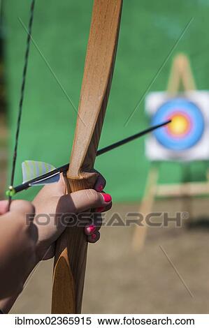 Stock Photography - "Archer aiming bow and arrow at target, Hesse, Germany, Europe". Fotosearch