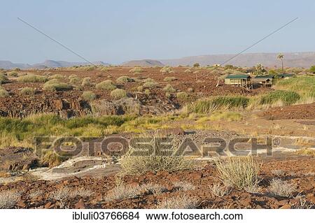 "Arid landscape with hut and spring at Palmwag Lodge, Kunene Region, Namibia, Africa" View Large Photo Image Picture - "Arid landscape with hut and spring at Palmwag Lodge, Kunene Region, Namibia, Africa". Fotosearch