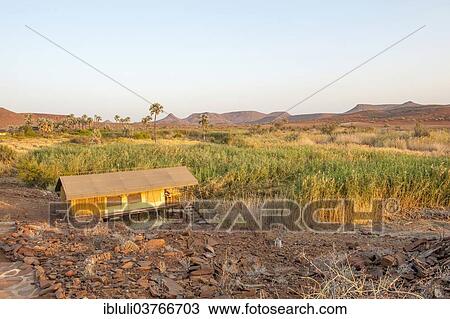 "Arid landscape with hut and spring at Palmwag Lodge, Kunene Region, Namibia, Africa" View Large Photo Image Stock Image - "Arid landscape with hut and spring at Palmwag Lodge, Kunene Region, Namibia, Africa". Fotosearch