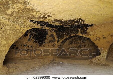 Stock Image - "Artificial caves in the cliff, dwelling, beach of Matala, Crete, Greece, Europe". Fotosearch