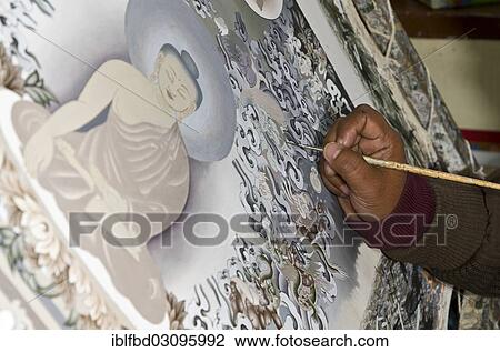 Stock Image - "Artist painting a big Thangka in an art school, Kathmandu Valley, Kathmandu, Kathmandu District, Bagmati Zone, Nepal, Asia". Fotosearch