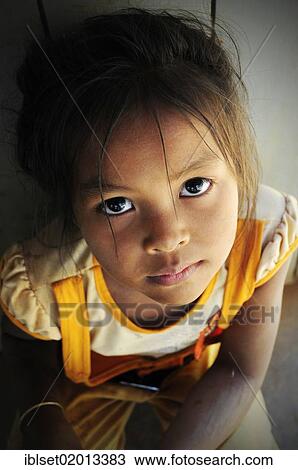 Stock Image - "Asian girl looking up sadly, Cambodia, Southeast Asia, Asia". Fotosearch