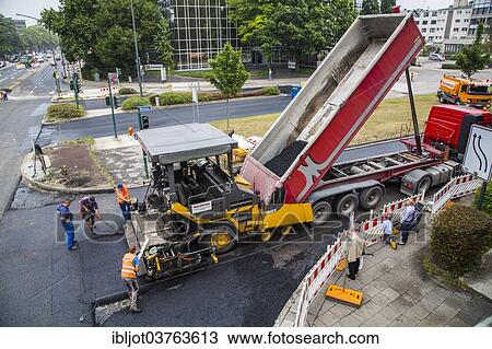 "Asphalt spreader during asphalt work on a large urban road construction site, Essen, North Rhine-Westphalia, Germany, Europe" View Large Photo Image Stock Image - "Asphalt spreader during asphalt work on a large urban road construction site, Essen, North Rhine-Westphalia, Germany, Europe". Fotosearch