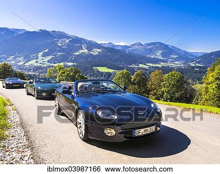 Stock Photograph - "Aston Martin DB7 Vantage Volange cars on a mountain road near Kitzbuhel, Tyrol, Austria, Europe". Fotosearch