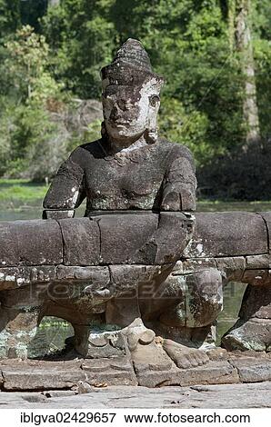 Stock Photo - "Asura statue bearing the giant snake Naga, on the balustrade of the causeway to the Preah Khan Temple, Angkor, Siem Reap, Cambodia, Southeast Asia, Asia". Fotosearch
