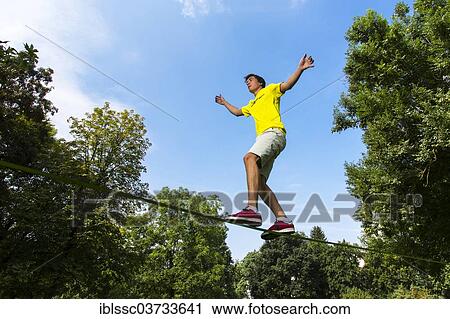 "Athlete balancing on a slackline, Waiblingen, Baden-Wurttemberg, Germany, Europe" View Large Photo Image Stock Image - "Athlete balancing on a slackline, Waiblingen, Baden-Wurttemberg, Germany, Europe". Fotosearch
