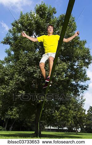 "Athlete balancing on a slackline, Waiblingen, Baden-Wurttemberg, Germany, Europe" View Large Photo Image Stock Image - "Athlete balancing on a slackline, Waiblingen, Baden-Wurttemberg, Germany, Europe". Fotosearch