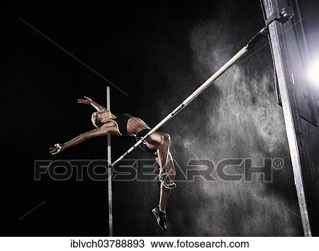 Stock Image - Athlete doing a high jump. Fotosearch
