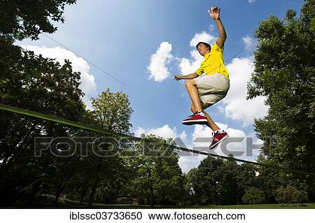 "Athlete jumping on a slackline, Waiblingen, Baden-Wurttemberg, Germany, Europe" View Large Photo Image Stock Image - "Athlete jumping on a slackline, Waiblingen, Baden-Wurttemberg, Germany, Europe". Fotosearch
