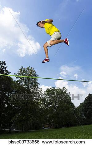 "Athlete jumping on a slackline, Waiblingen, Baden-Wurttemberg, Germany, Europe" View Large Photo Image Stock Photograph - "Athlete jumping on a slackline, Waiblingen, Baden-Wurttemberg, Germany, Europe". Fotosearch